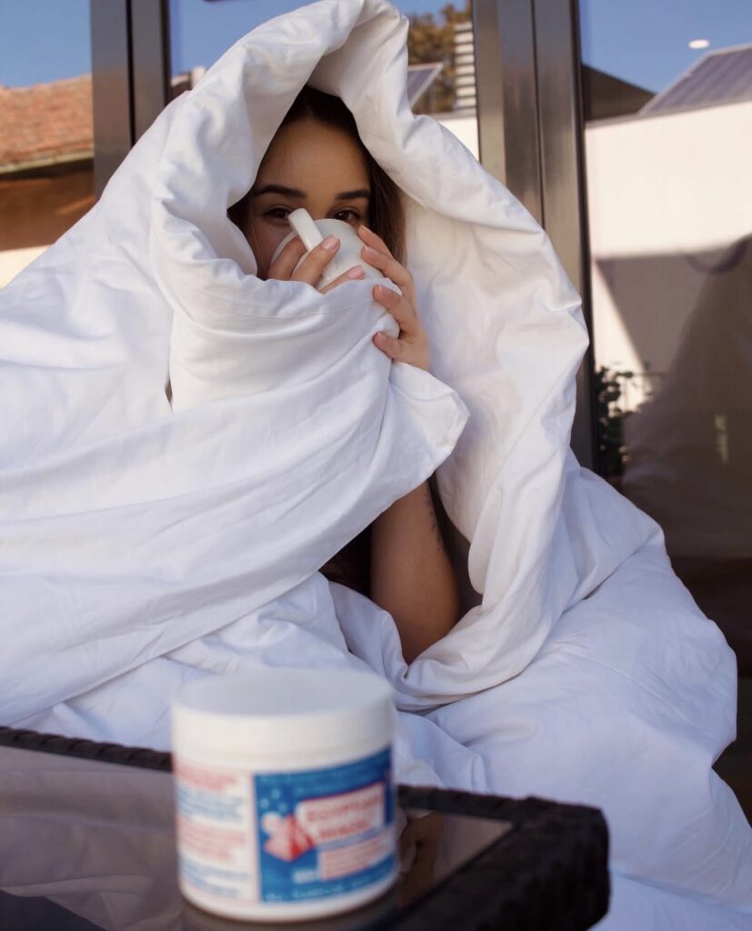 woman cozy with blanket and mug and balm